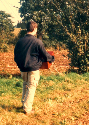 Chris takes the coffin across the fields with care.
